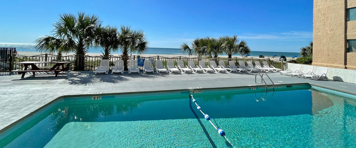 Exterior view of a hotel pool with a view of the ocean